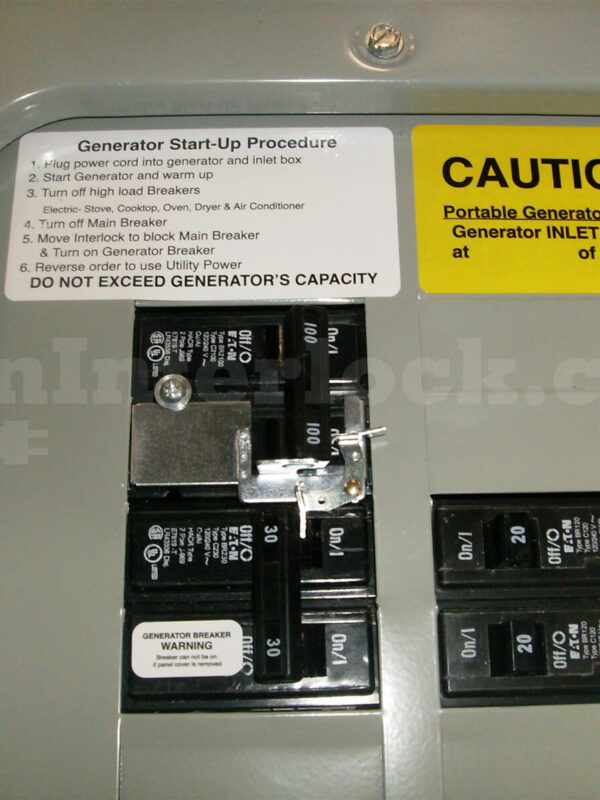 Eaton Cutler-Hammer 21601 Generator Interlock Kit Installed on Panel with Caution and Start-Up Labels