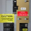GE 31206 Generator Interlock Kit Installed on Breaker Panel with Caution Labels